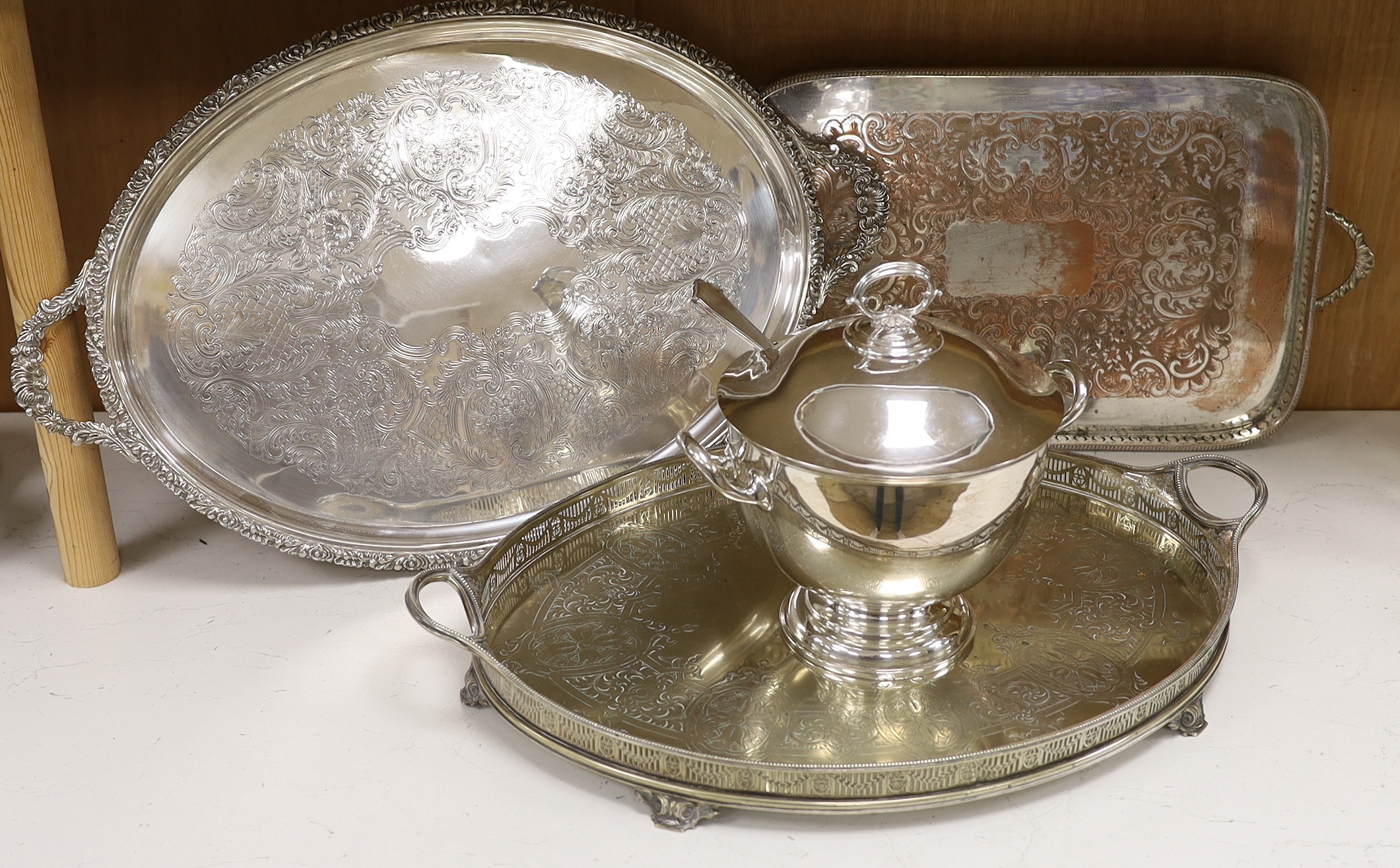 Four items of plated wares; a Victorian galleried tray, a soup tureen and two other trays, largest tray 67cm
